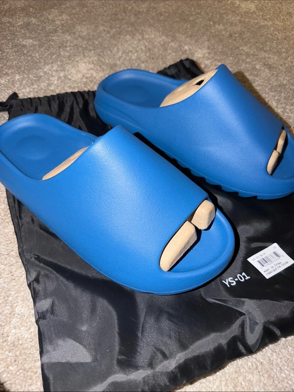foam runner/slides inspired by Yeezy‎ designs. The bag says “YS-01,”